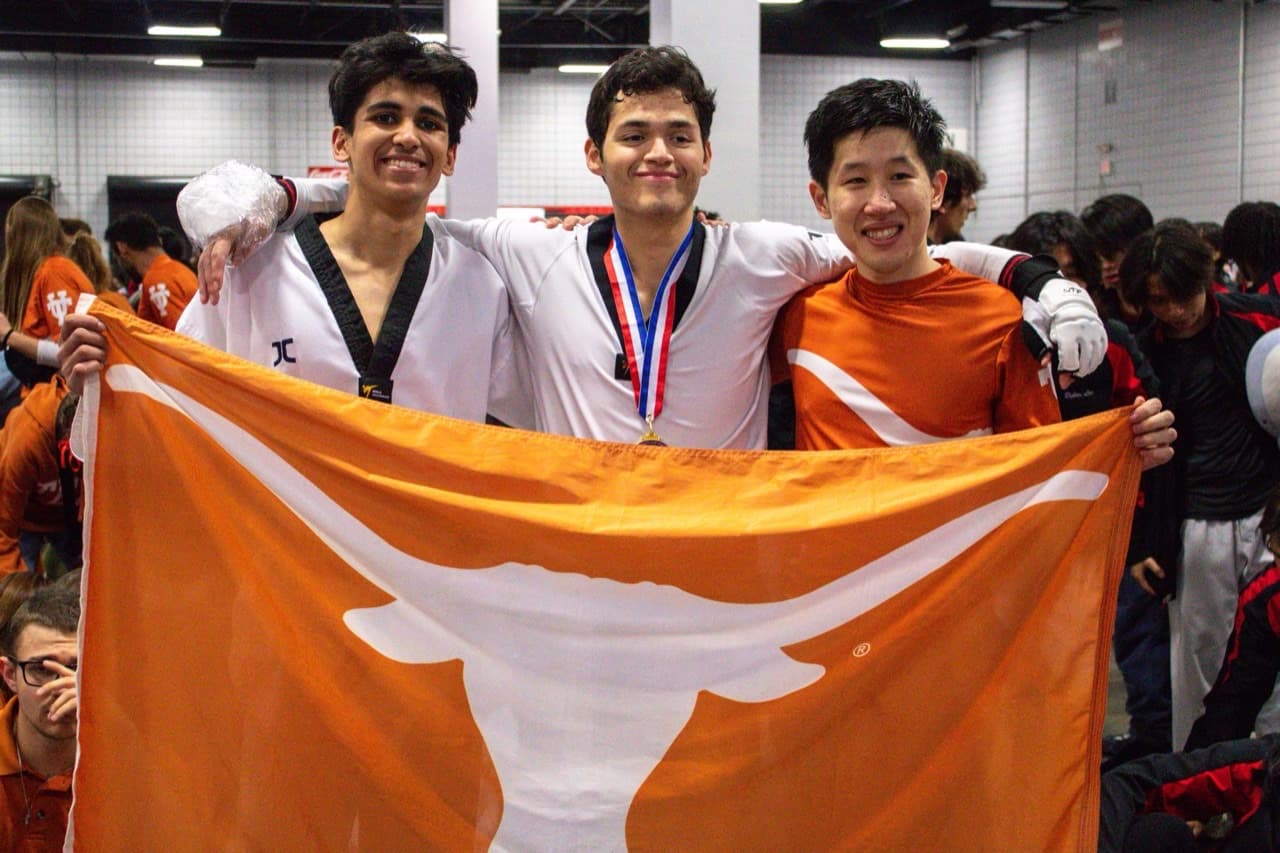 Arav and teammates holding a Texas flag after a taekwondo competition