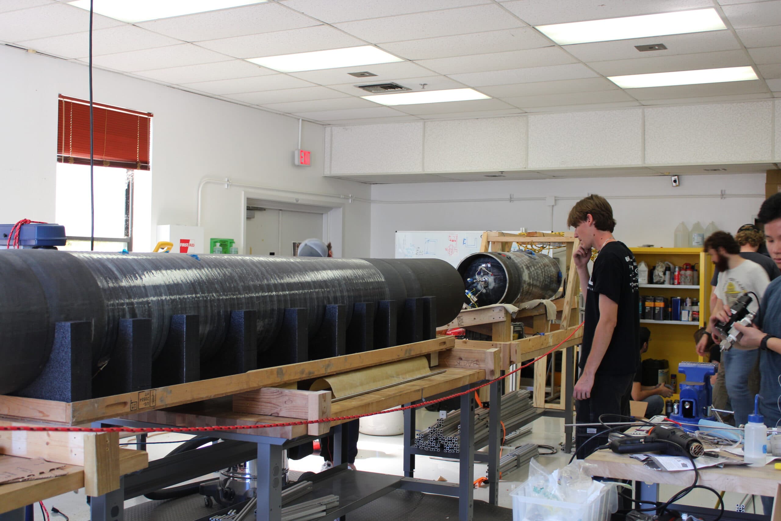 Texas Rocket Engineering Lab students working on a carbon-fiber rocket body